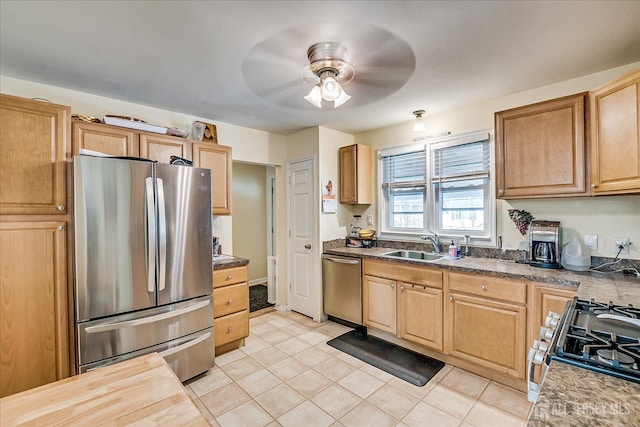 kitchen featuring stainless steel appliances, light tile patterned flooring, sink, and ceiling fan