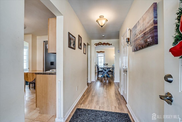 hallway featuring light tile patterned floors