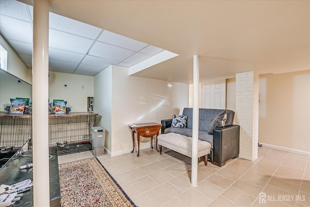 interior space with light tile patterned floors and a paneled ceiling