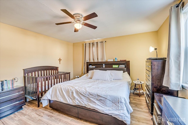 bedroom with ceiling fan and light hardwood / wood-style flooring