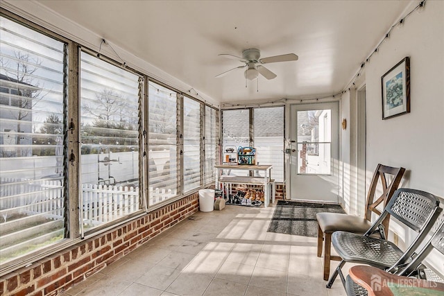 sunroom featuring ceiling fan