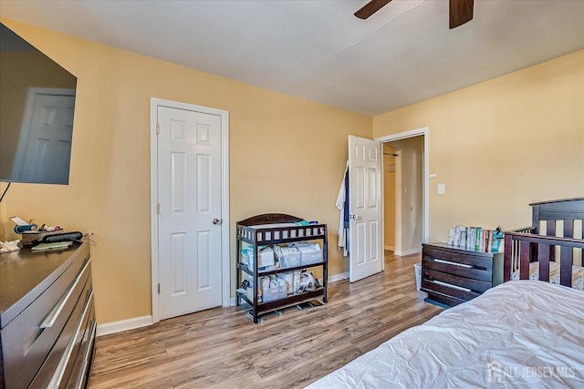 bedroom with ceiling fan and light hardwood / wood-style floors