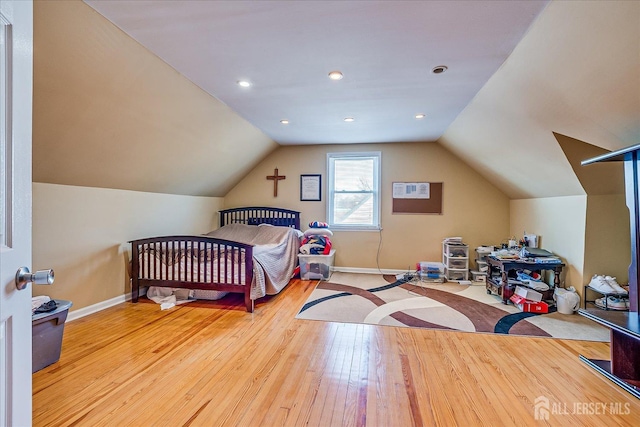 bedroom featuring lofted ceiling and light wood-type flooring