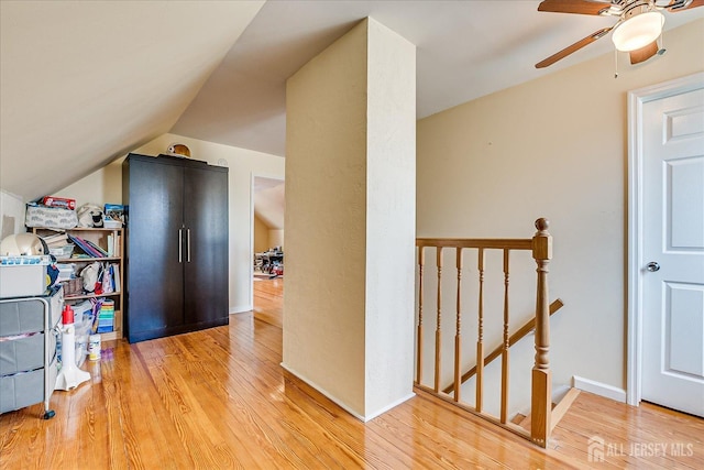 interior space with hardwood / wood-style flooring, ceiling fan, and vaulted ceiling