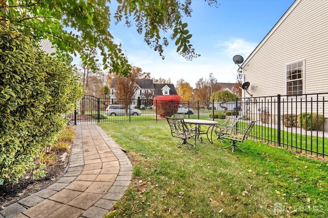 view of property's community featuring a yard, fence, and a residential view