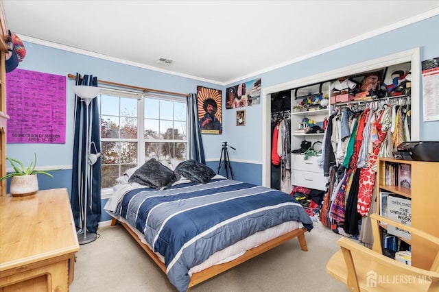 bedroom with ornamental molding, a closet, visible vents, and light colored carpet