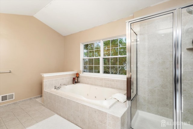 bathroom featuring lofted ceiling, a tub with jets, a shower stall, and visible vents