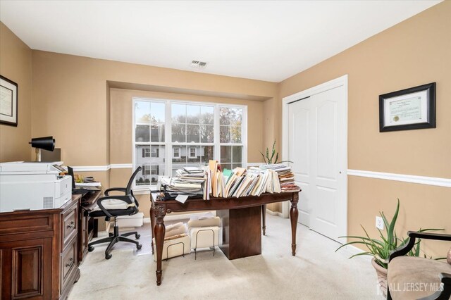 office featuring light carpet and visible vents