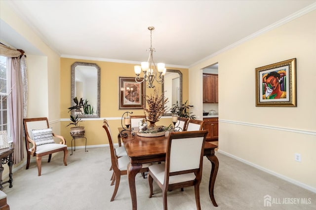 dining area featuring light carpet, ornamental molding, baseboards, and a notable chandelier