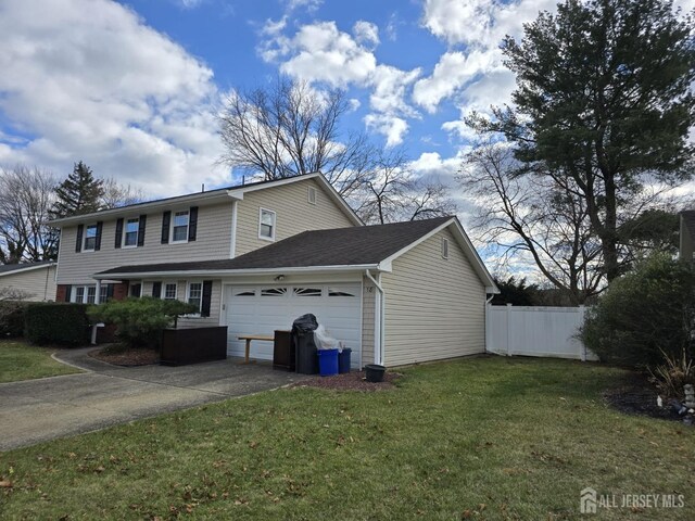 view of side of property featuring a garage and a yard