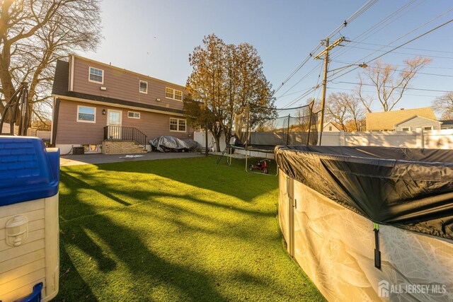 view of yard with a trampoline