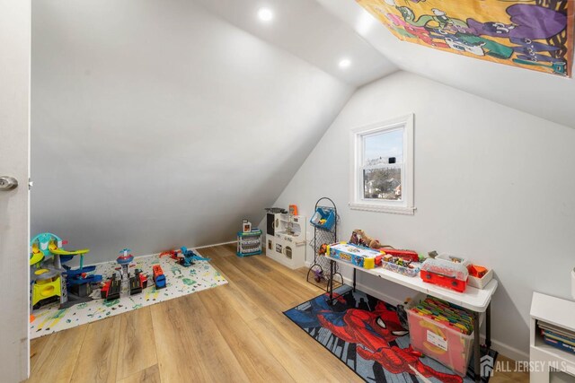 rec room featuring hardwood / wood-style flooring and vaulted ceiling