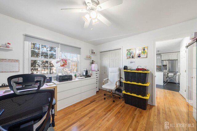 home office featuring ceiling fan and light wood-type flooring