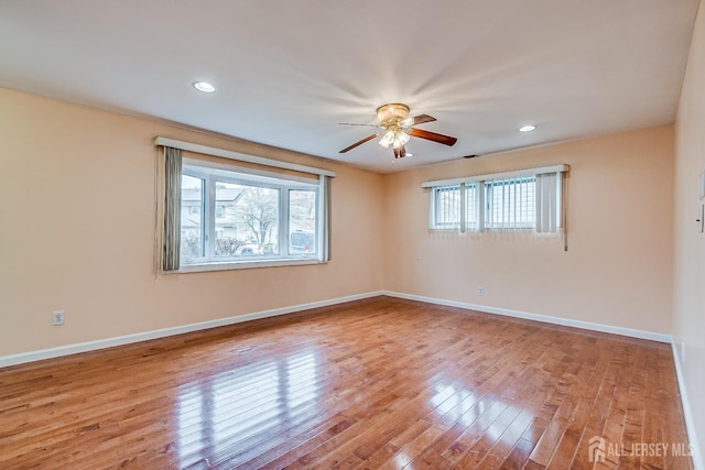 empty room featuring wood finished floors, ceiling fan, baseboards, and recessed lighting