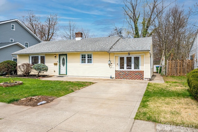view of front of property with a chimney, driveway, a shingled roof, and brick siding