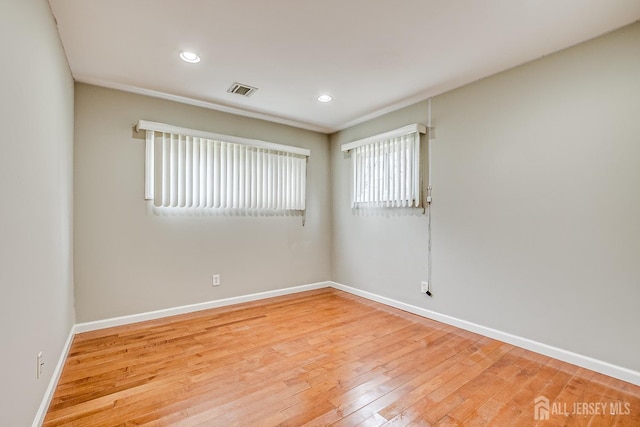 unfurnished room featuring light wood-style flooring, baseboards, and recessed lighting