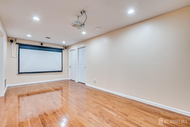 cinema featuring baseboards, wood finished floors, and recessed lighting