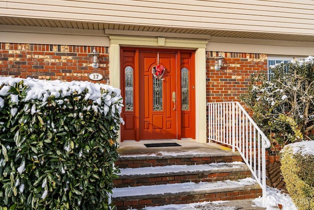 view of snow covered property entrance