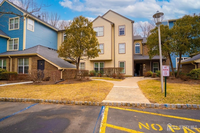 view of building exterior featuring uncovered parking