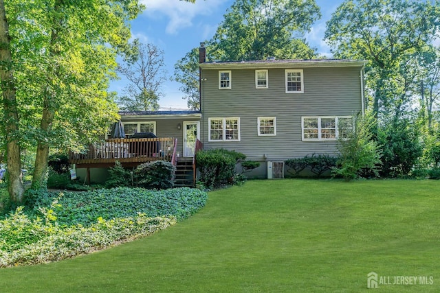 view of front of house featuring a wooden deck, a front lawn, and central air condition unit