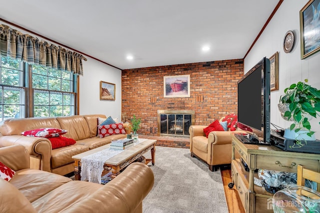 living room with ornamental molding and a brick fireplace