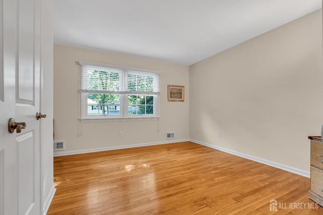 empty room with light hardwood / wood-style flooring