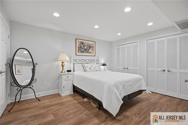 bedroom featuring multiple closets, recessed lighting, wood finished floors, and baseboards