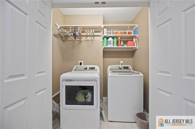 clothes washing area with separate washer and dryer