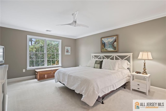 bedroom featuring ornamental molding, light colored carpet, baseboards, and a ceiling fan