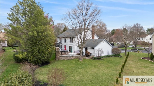 view of green lawn with a patio
