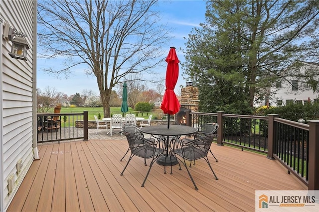 wooden terrace with outdoor dining area