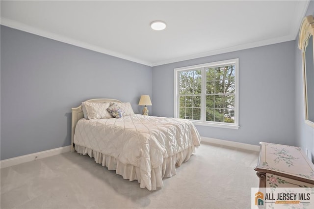 carpeted bedroom with baseboards and crown molding