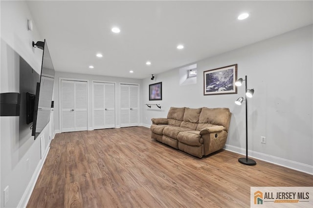 living room with baseboards, recessed lighting, and wood finished floors