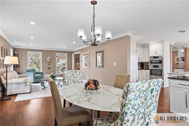 dining room featuring a chandelier, crown molding, recessed lighting, and dark wood-style floors