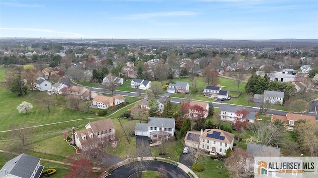 aerial view of property and surrounding area featuring nearby suburban area