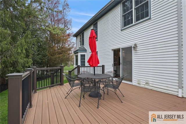 deck with outdoor dining area