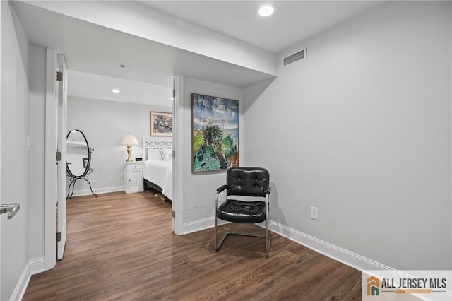corridor featuring wood finished floors, recessed lighting, and baseboards
