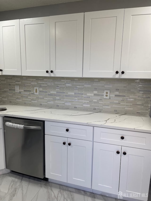 kitchen featuring white cabinets, light stone countertops, and dishwasher