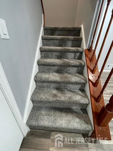 stairs with hardwood / wood-style flooring