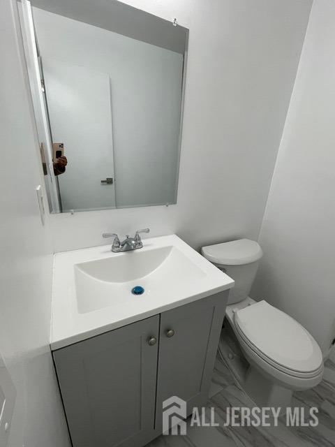 bathroom featuring vanity and toilet