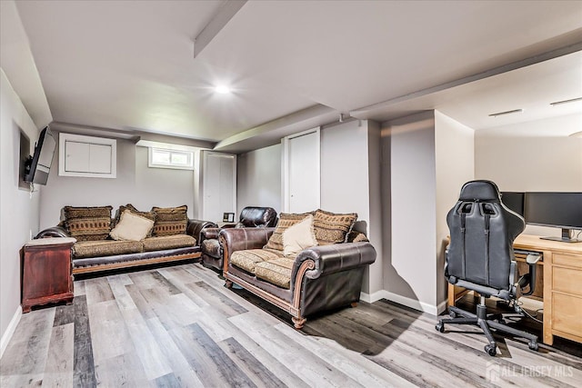 living room featuring wood finished floors, a desk, baseboards, and recessed lighting