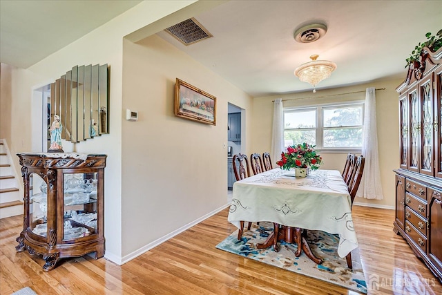 dining area featuring light wood finished floors and baseboards