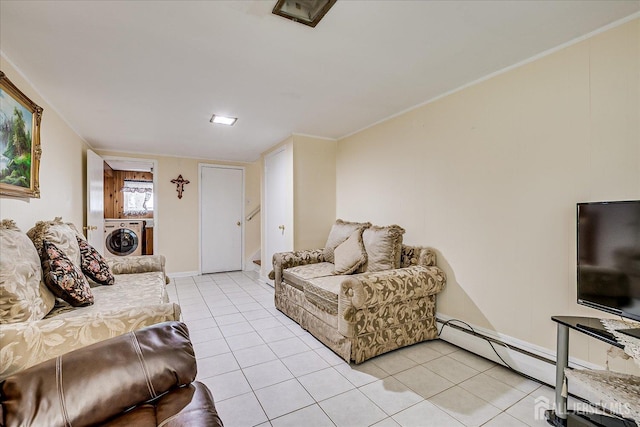 living room featuring washer / dryer, light tile patterned flooring, baseboards, and baseboard heating
