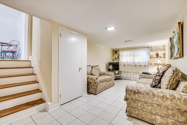 living room featuring light tile patterned floors and stairs