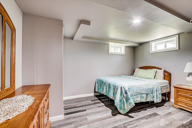 bedroom featuring wood finished floors and baseboards