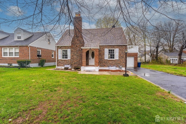 334 Hillcrest Ave, Plainfield, NJ 07062 - view of front facade with brick siding, asphalt driveway, a chimney, and a front yard