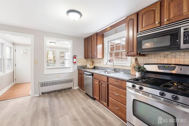 334 Hillcrest Ave, Plainfield, NJ 07062 - kitchen featuring stainless steel appliances, radiator heating unit, a sink, and healthy amount of natural light