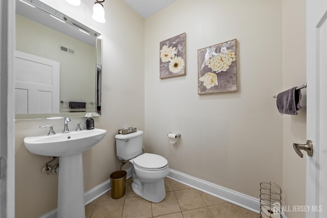 20 Mccormick Ave, Old Bridge, NJ 08857 - bathroom featuring baseboards, toilet, tile patterned floors, and a sink