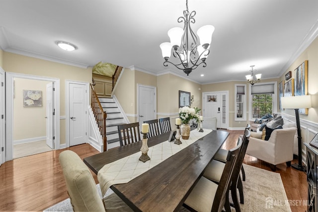 20 Mccormick Ave, Old Bridge, NJ 08857 - dining space featuring a chandelier, wood finished floors, stairs, ornamental molding, and baseboards