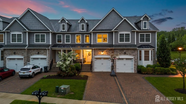 20 Mccormick Ave, Old Bridge, NJ 08857 - townhome / multi-family property featuring driveway, a garage, stone siding, and covered porch